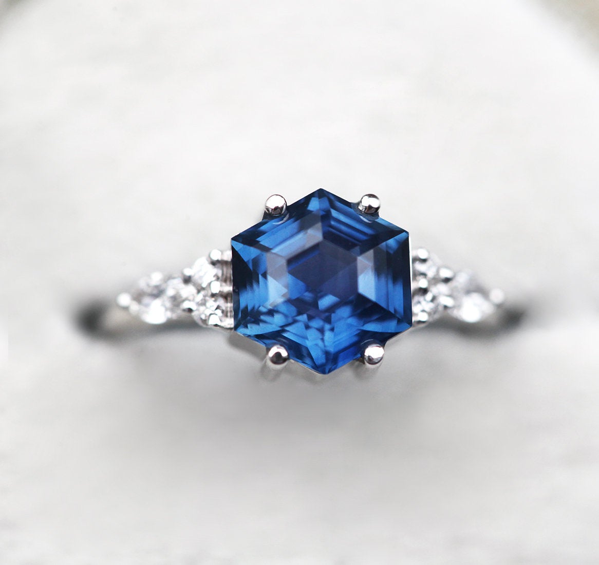 Blue hexagon-shaped sapphire ring with side diamonds