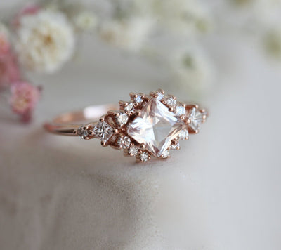 Square-shaped peach pink sapphire ring with diamond cluster