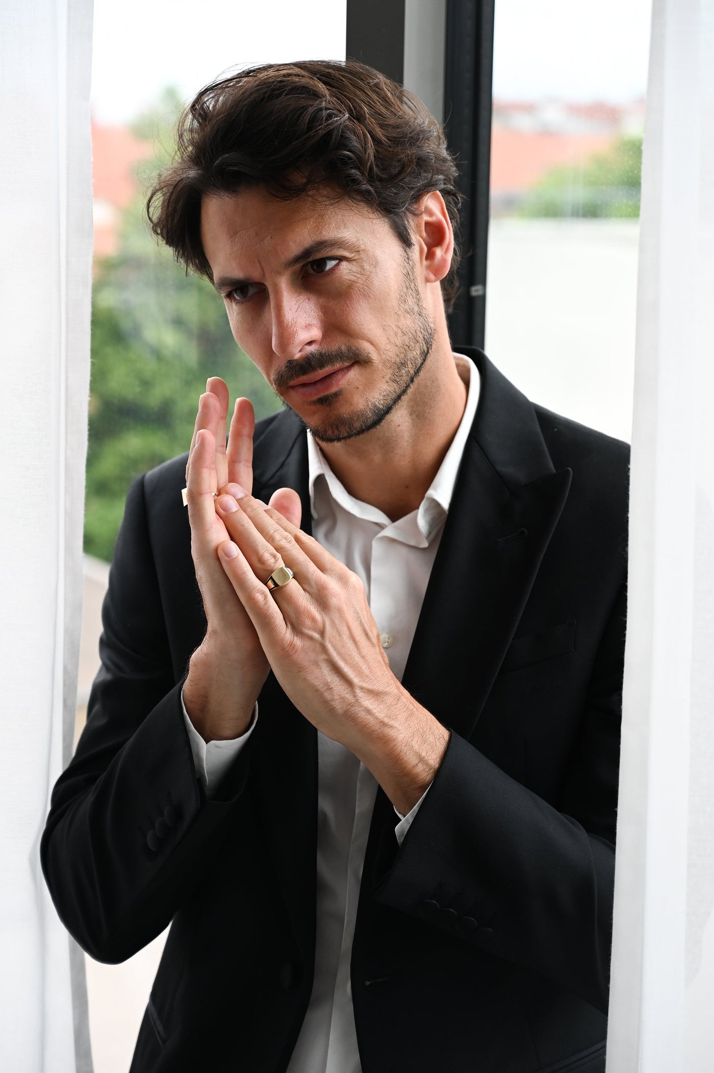 A man in a suit with a ring.