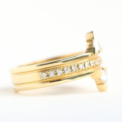 Gold ring with 2 triangular white diamonds with a middle eternity diamond ring