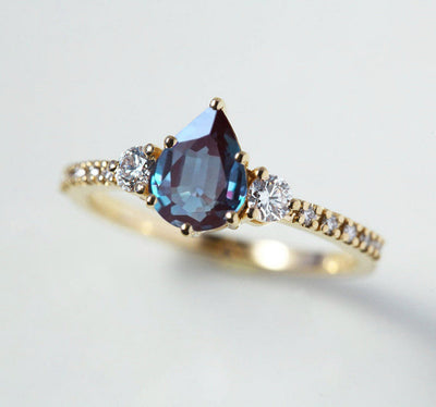Teal Pear Alexandrite Ring with Side Round White Diamonds and Diamonds in the band