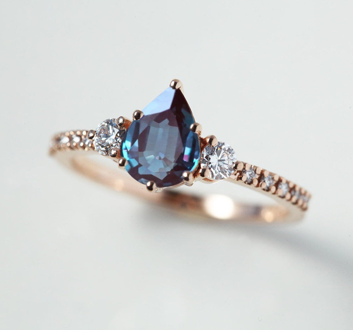 Teal Pear Alexandrite Ring with Side Round White Diamonds and Diamonds in the band