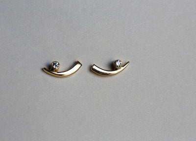 Claw-shaped stud earrings with round white diamonds