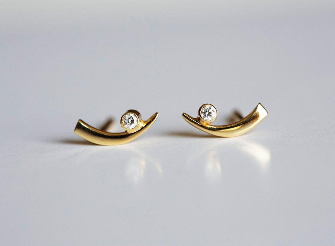 Claw-shaped stud earrings with round white diamonds