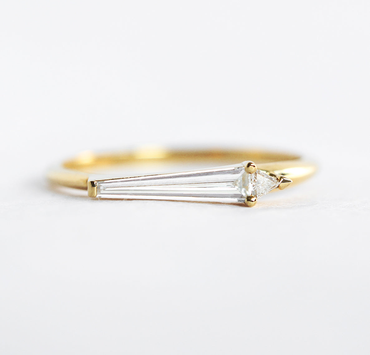 Tapered Baguette White Diamond Art Deco Ring featuring a Triangular Side Diamond
