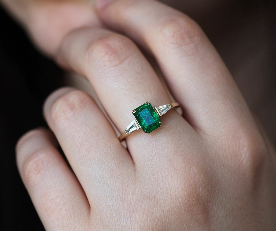 Diamond engagement ring with shops emerald accents