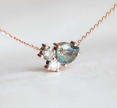 Pear-shaped teal sapphire and round diamond cluster gold necklace