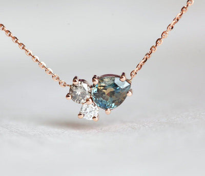 Pear-shaped teal sapphire and round diamond cluster gold necklace