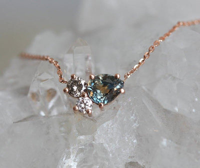 Pear-shaped teal sapphire and round diamond cluster gold necklace