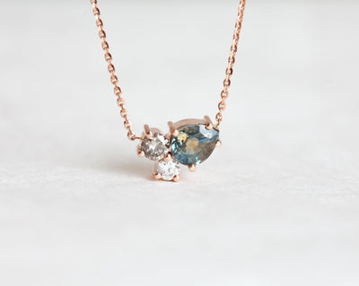 Pear-shaped teal sapphire and round diamond cluster gold necklace