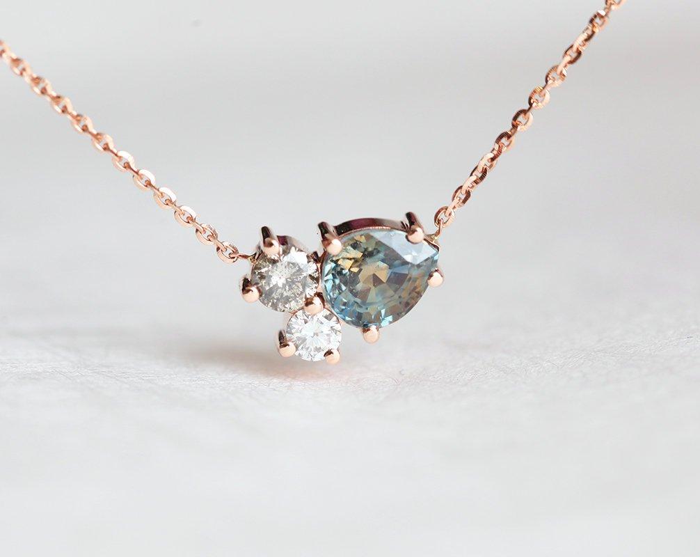 Pear-shaped teal sapphire and round diamond cluster gold necklace