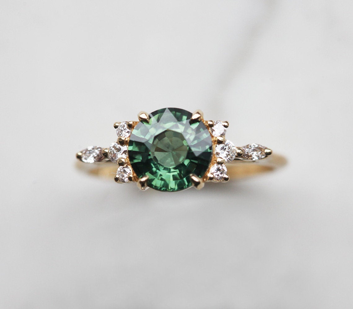 Round green sapphire ring with diamond cluster