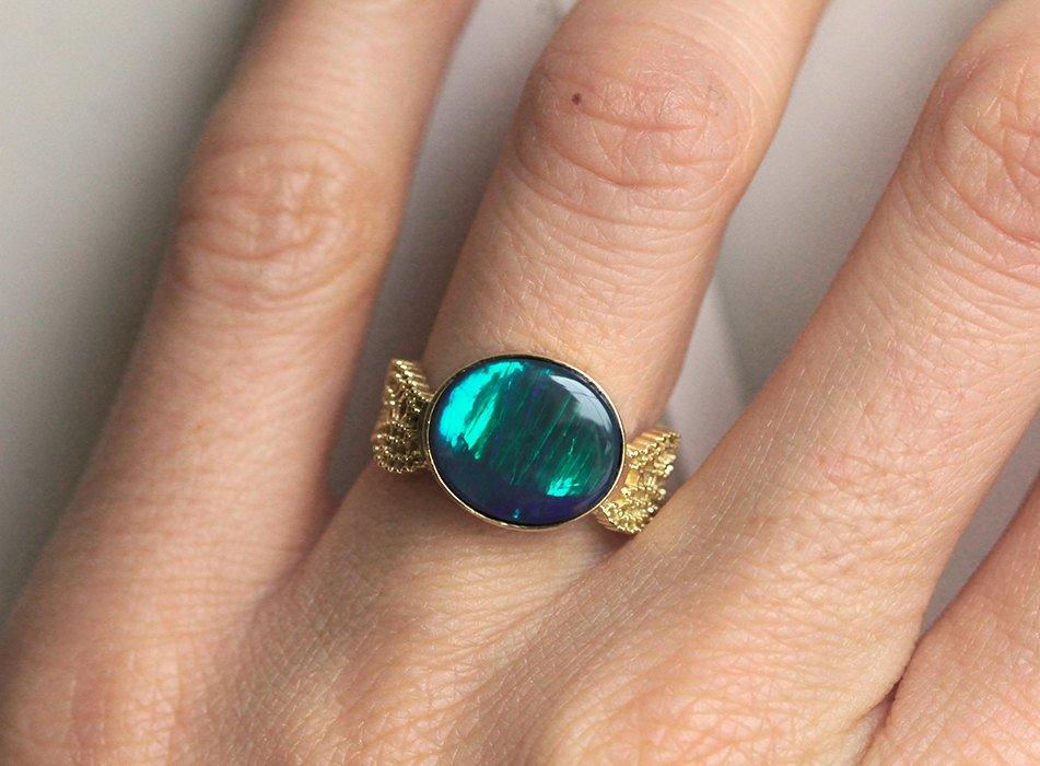 Black Oval Opal Gold Ring with Opal as Centerpiece Adorned By Vintage Lace On The Sides