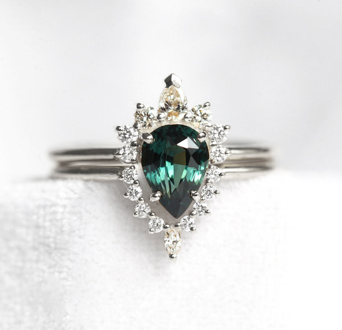 Pear-shaped teal sapphire ring with diamond halo