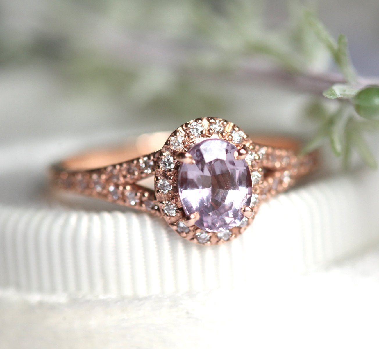 Oval lavender sapphire ring with diamond halo