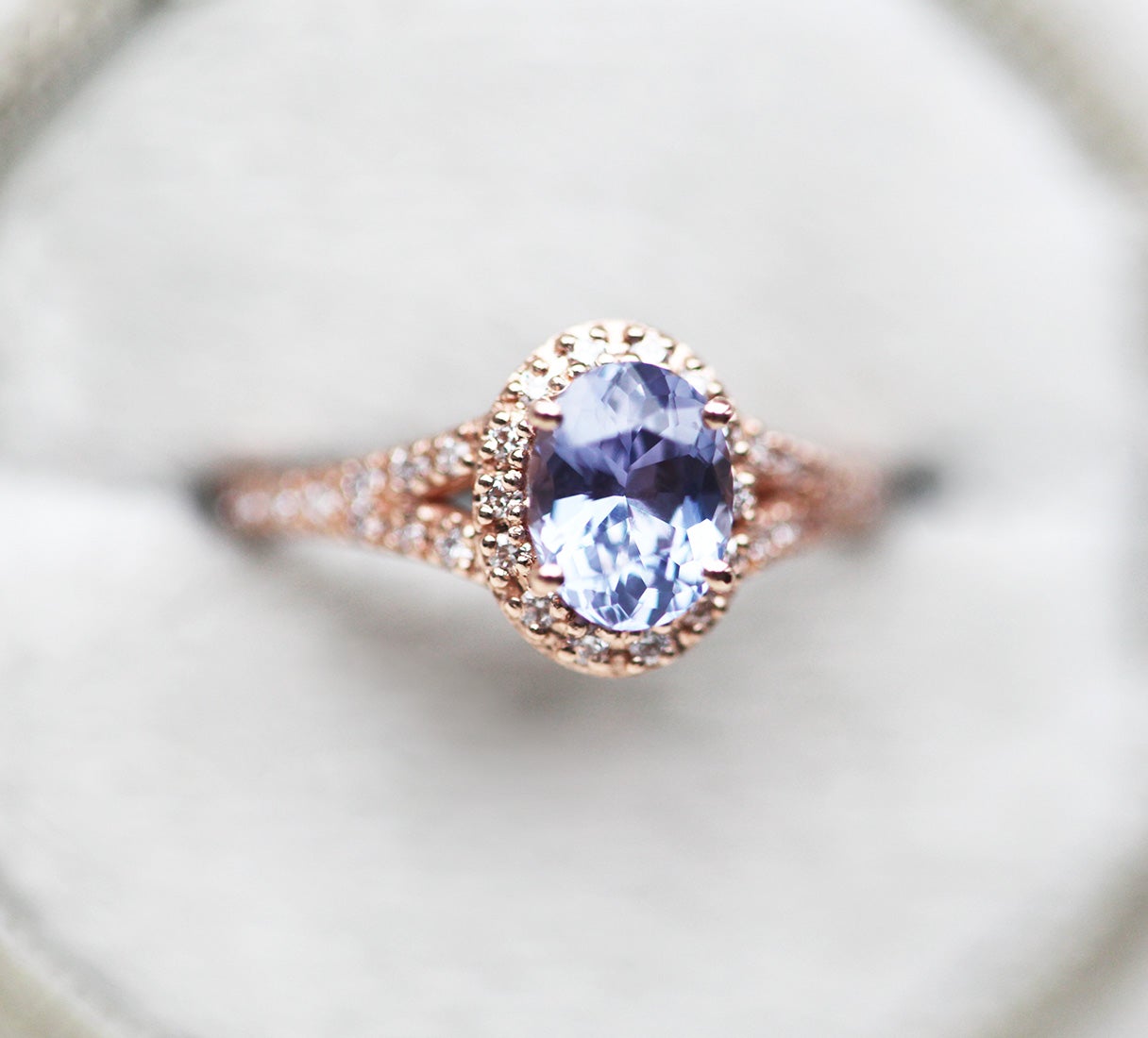 Oval lavender sapphire ring with diamond halo