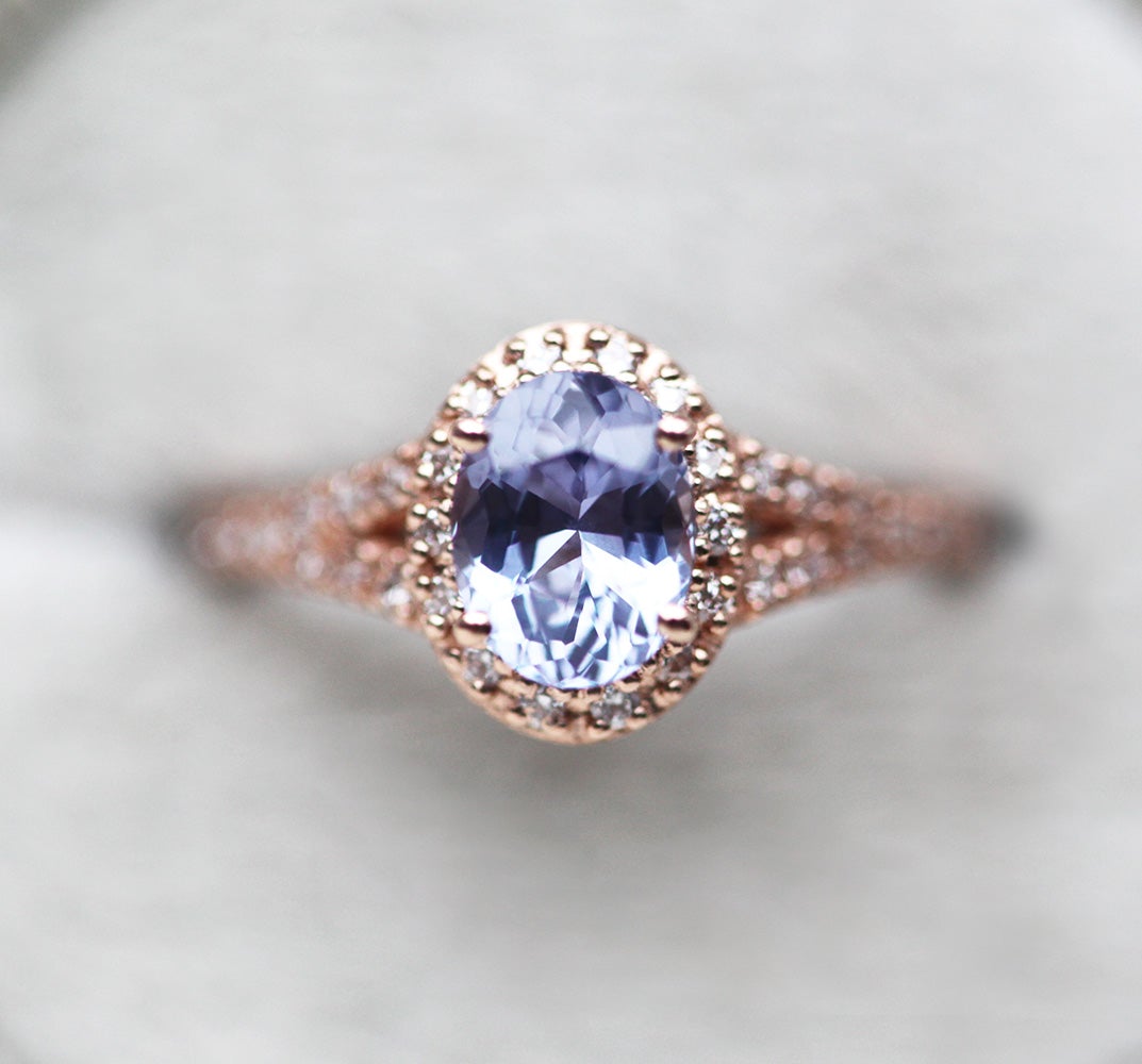 Oval lavender sapphire ring with diamond halo