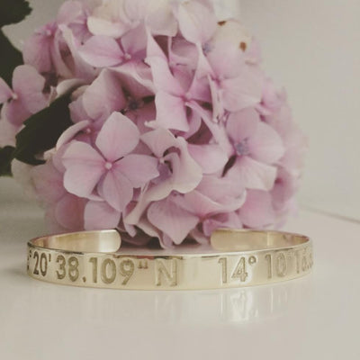 Solid gold cuffed bracelet with personalized coordinate engraving