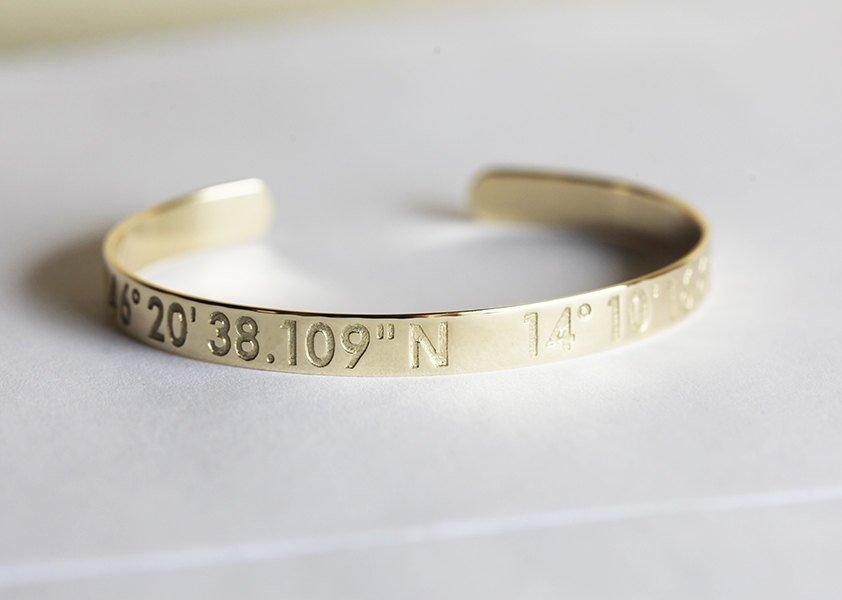 Solid gold cuffed bracelet with personalized coordinate engraving