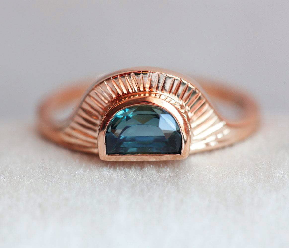 Half-moon-shaped teal sapphire ring