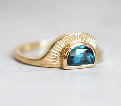 Half-moon-shaped teal sapphire ring