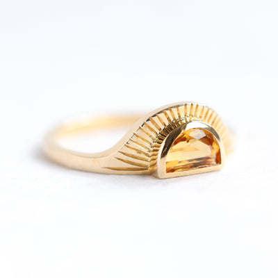 Half-moon-shaped golden orange sapphire ring