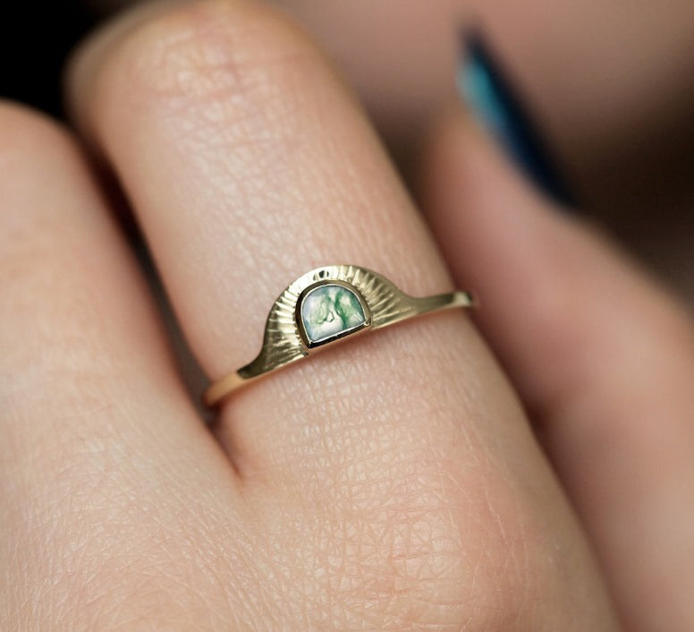 Close-up of a moss agate half-moon ring showcasing its intricate details.