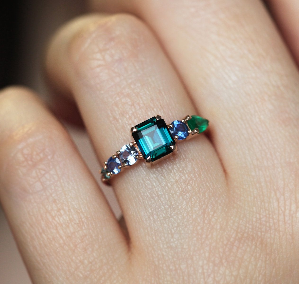 Emerald-shaped sapphire cluster ring with emeralds