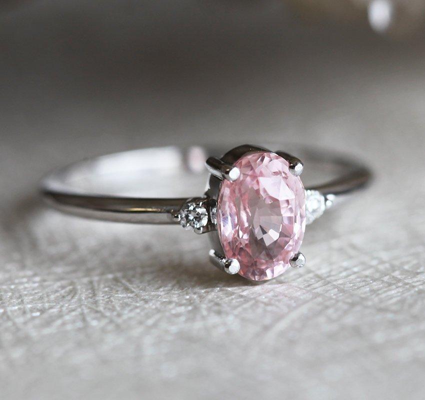 Oval peach sapphire ring with side diamonds