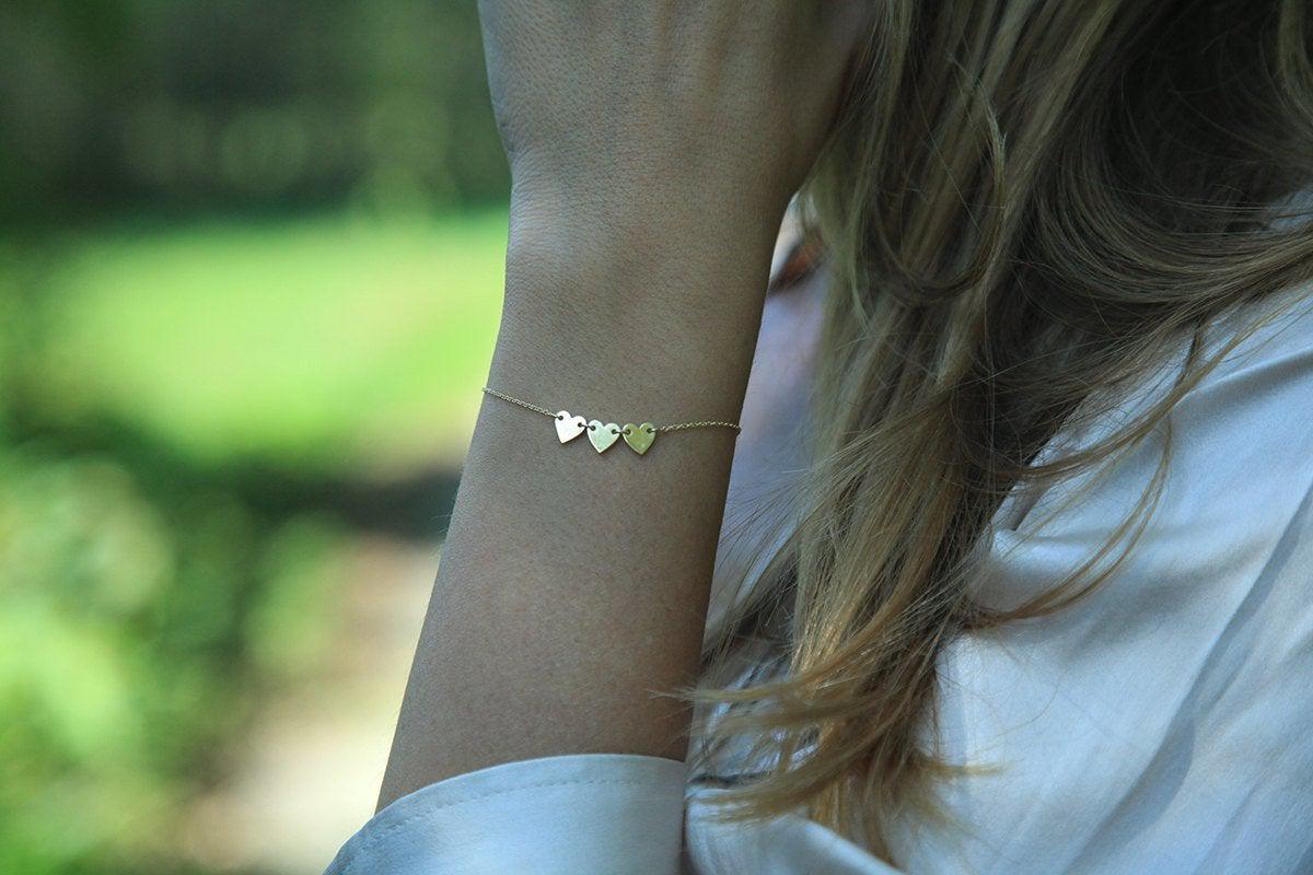 Gold chain bracelet with three heart charms and personalized initials