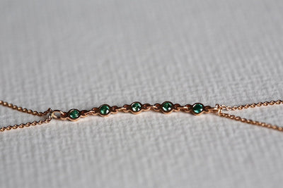 Rose gold body chain with round emeralds