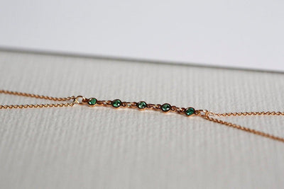 Rose gold body chain with round emeralds