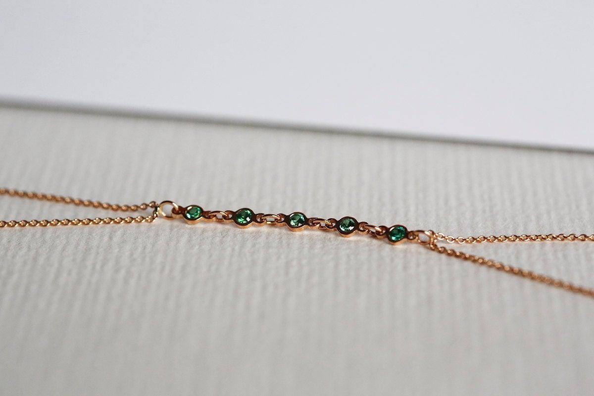 Rose gold body chain with round emeralds