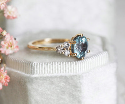 Round blue sapphire ring with side diamonds