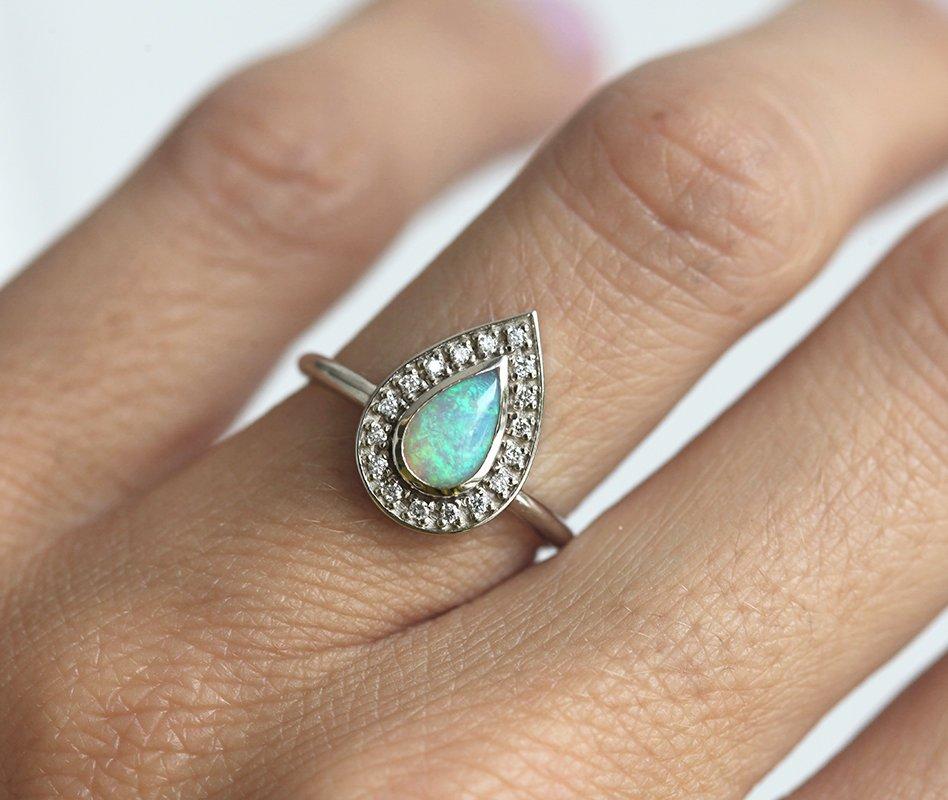 White Pear Opal Halo White Gold Ring with Round White Diamonds Surrounding The Main Gemstone