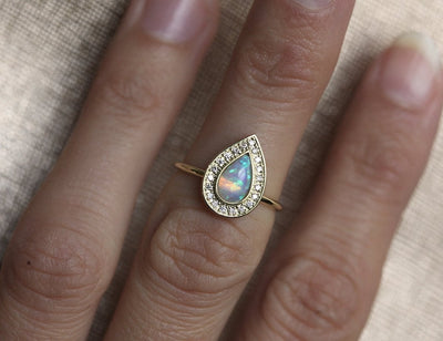 White Pear Opal Halo Yellow Gold Ring with Round White Diamonds Surrounding The Main Gemstone