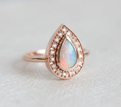 White Pear Opal Halo Rose Gold Ring with Round White Diamonds Surrounding The Main Gemstone