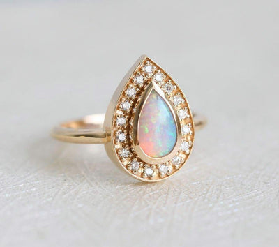 White Pear Opal Halo Yellow Gold Ring with Round White Diamonds Surrounding The Main Gemstone