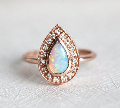 White Pear Opal Halo Rose Gold Ring with Round White Diamonds Surrounding The Main Gemstone