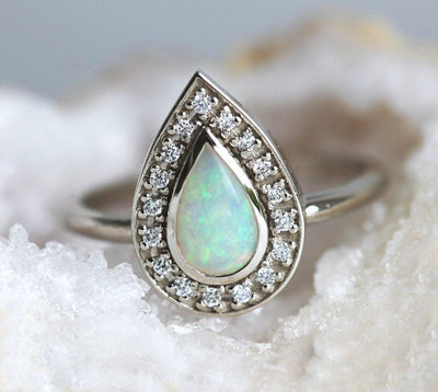 White Pear Opal Halo White Gold Ring with Round White Diamonds Surrounding The Main Gemstone