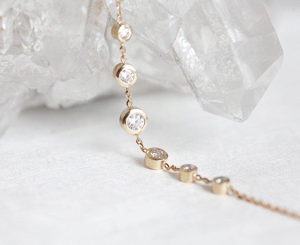 Gold choker necklace with round white diamonds