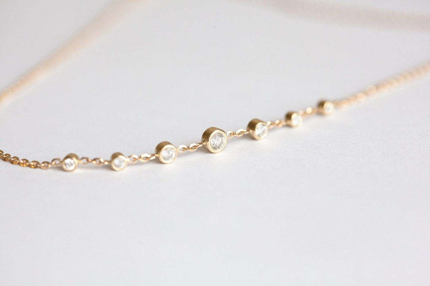 Gold choker necklace with round white diamonds