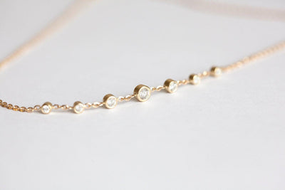 Gold choker necklace with round white diamonds