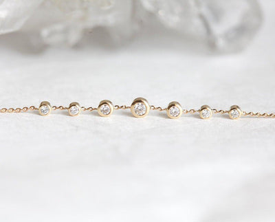 Gold choker necklace with round white diamonds