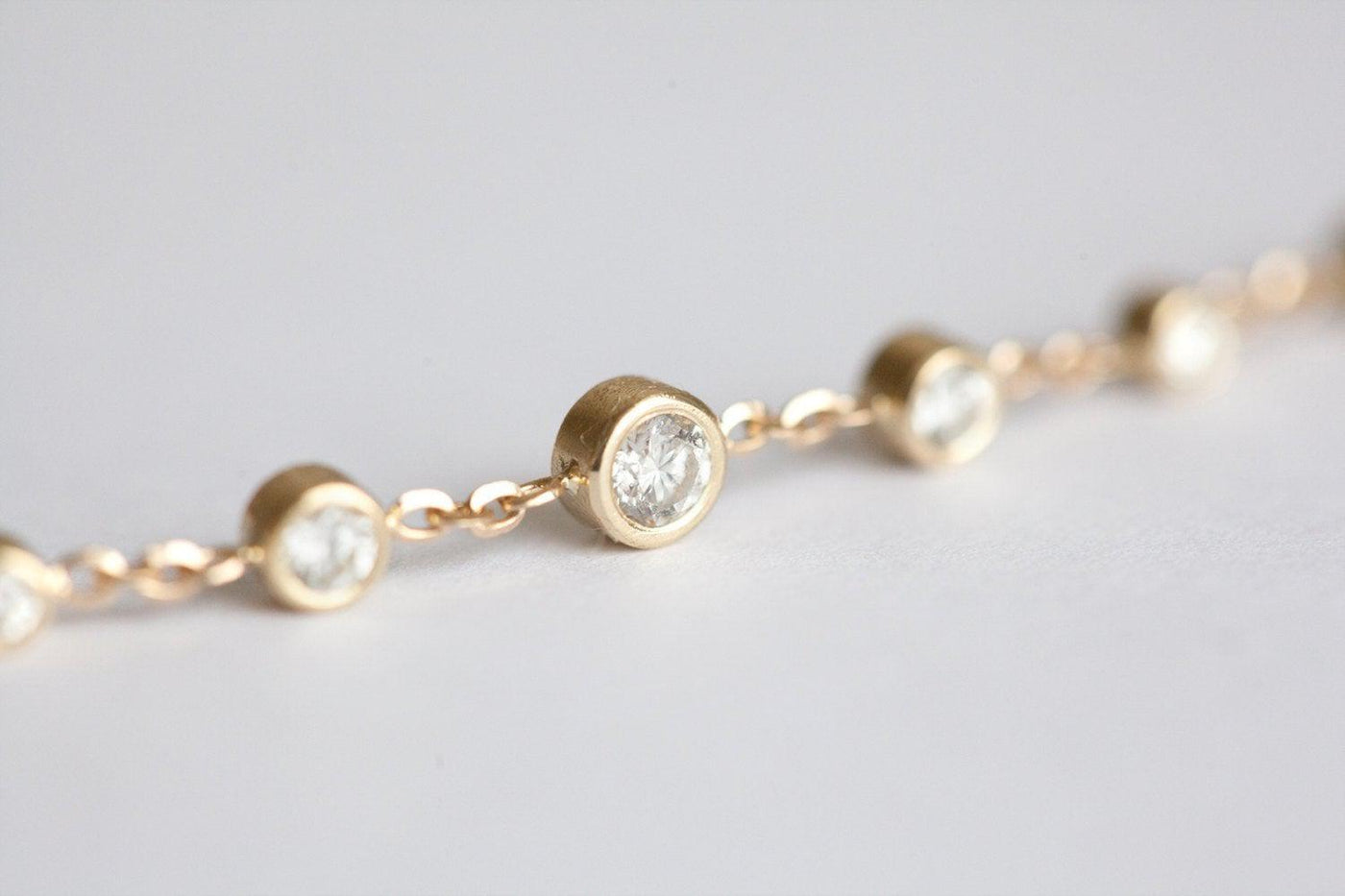 Gold choker necklace with round white diamonds