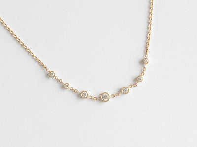 Gold choker necklace with round white diamonds