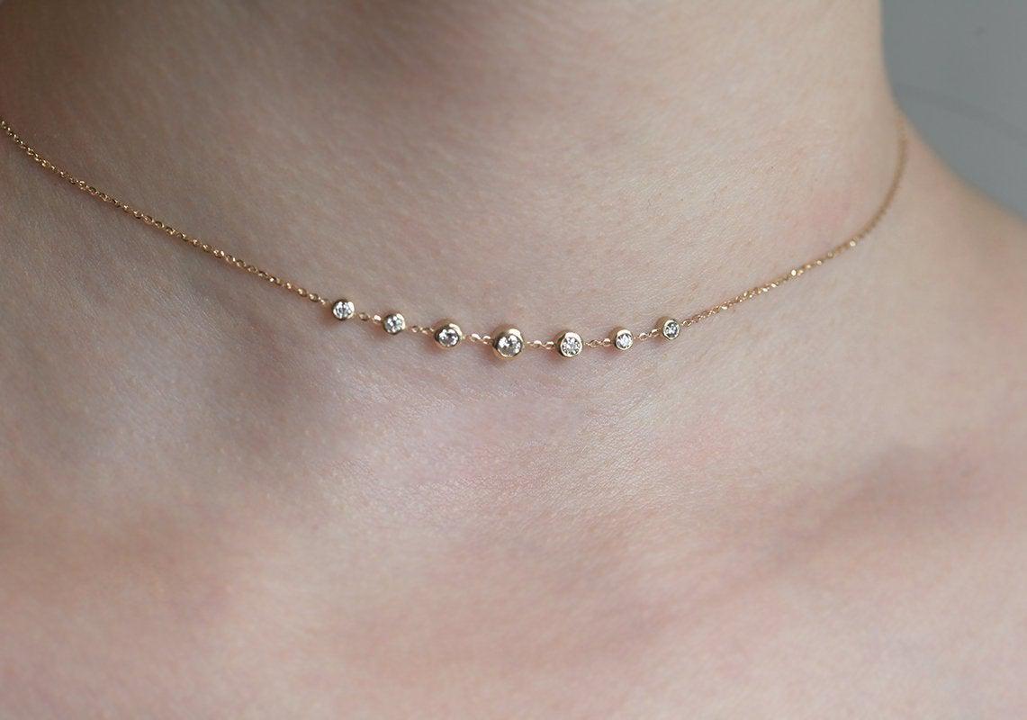 Gold choker necklace with round white diamonds