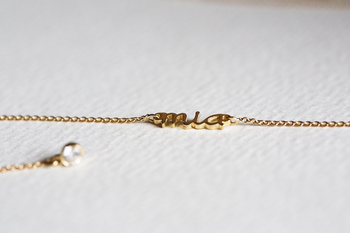 Gold lariat necklace with round white diamonds