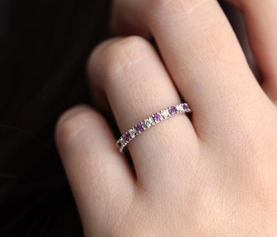 Round White Diamond Eternity Band with half of the patches filled with amethysts and the other half with diamonds