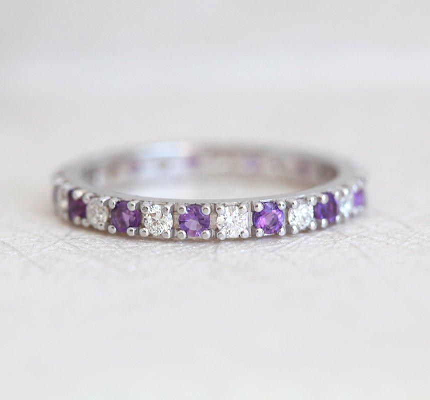 Round White Diamond Eternity Band with half of the patches filled with amethysts and the other half with diamonds